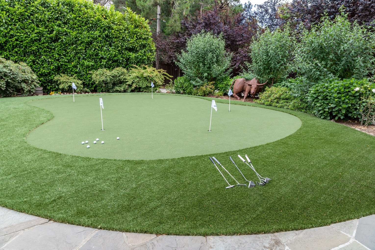 Custom putting green installation in residential backyard