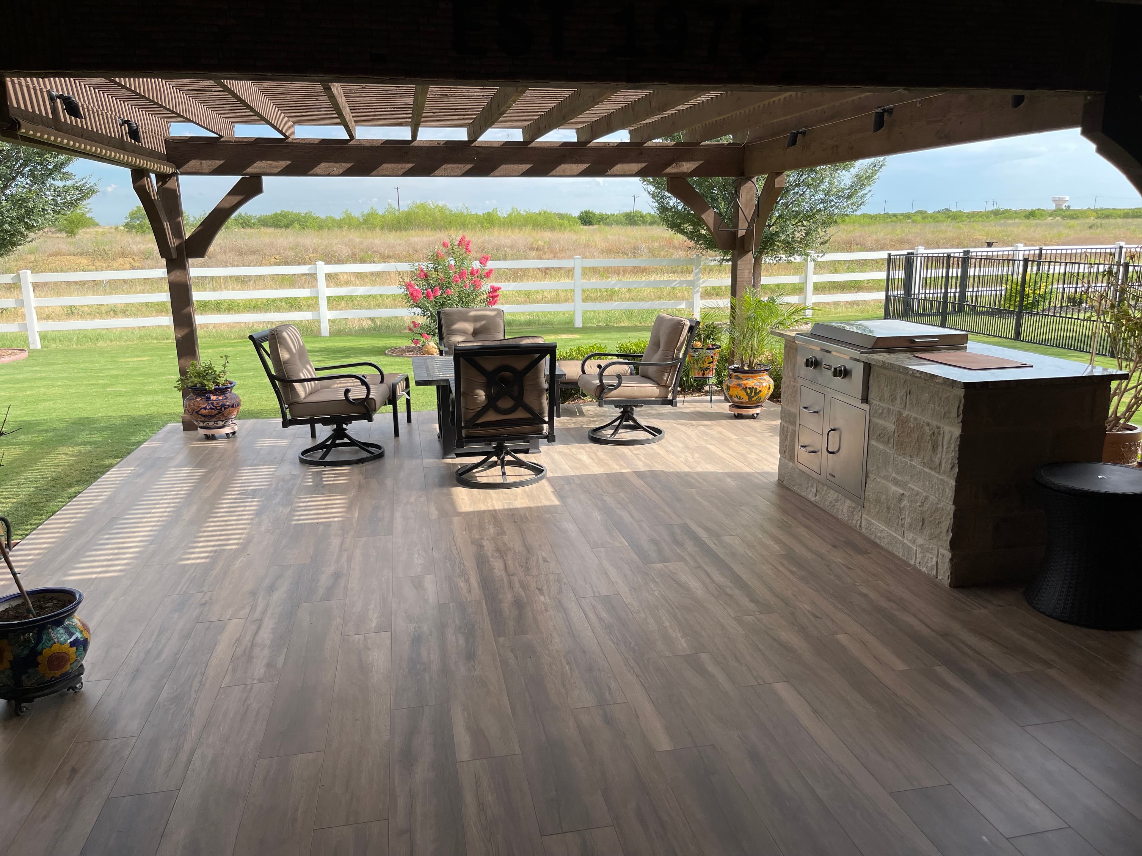 Covered patio with outdoor kitchen and seating area